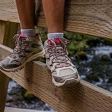 Merrell kids Moab 3 Mid Waterproof hike shoe, balancing on bridge